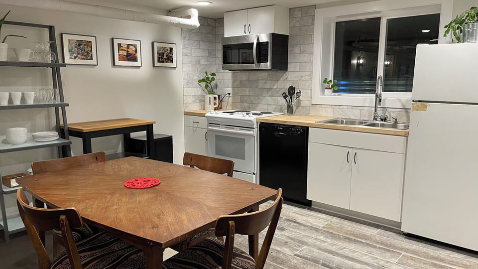 4 top dining table, island that can move, full size oven, stove, and dishwasher 