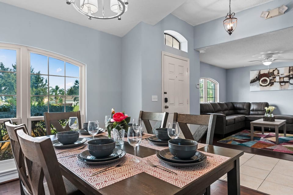 Stylishly set dining table in a bright and welcoming space.