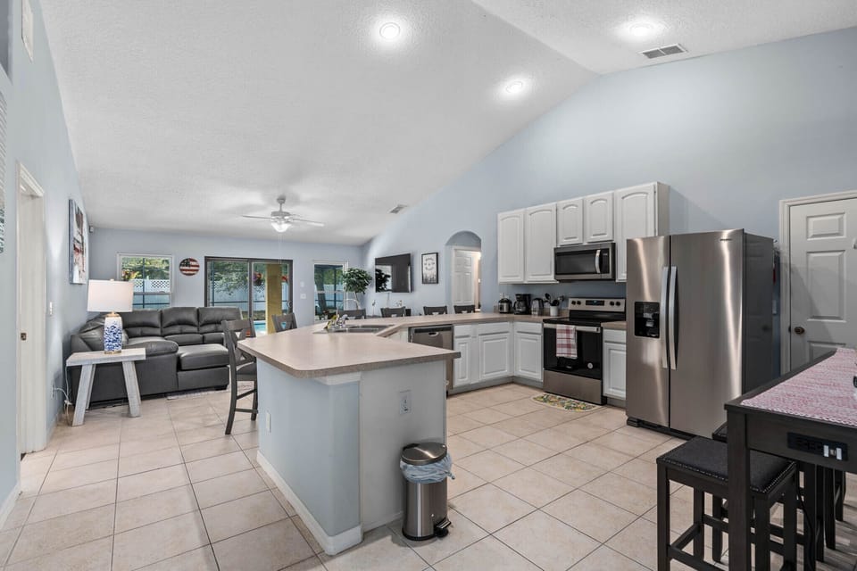 ully equipped modern kitchen with stainless steel appliances and ample counter space.