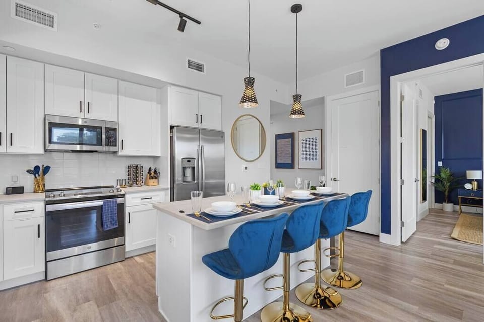 [Kitchen] - stainless steel appliances, large island w/ four person seating