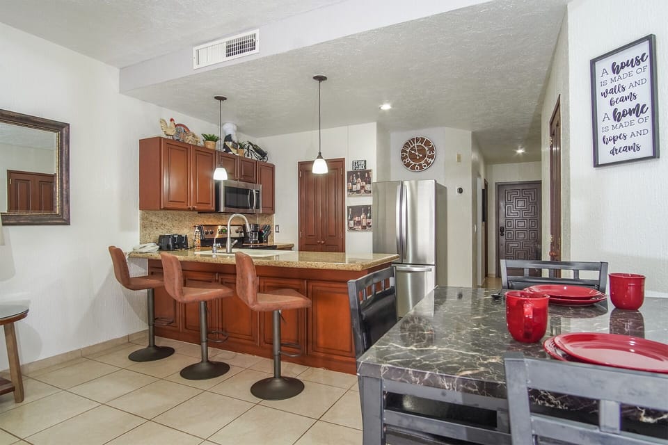 dining table and additional seating at the kitchen counter