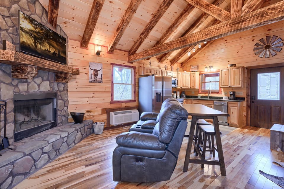 Close-up of Sitting Area and Fireplace, with Couple's table and Full Kitchen, beyond - Cowboy Trail cabin