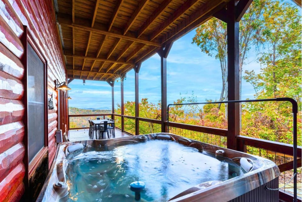 Relax on a hot tub on the deck with stunning mountain views  and autom hues