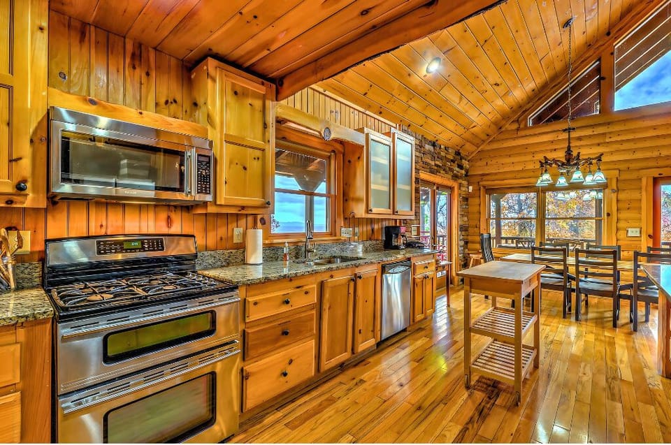 Rustic kitchen with granite counters, stainless appliances, and stunning views!