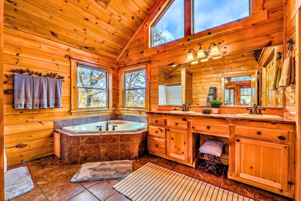 Charming bathroom with a soaking tub, dual vanities, and rustic wood accents