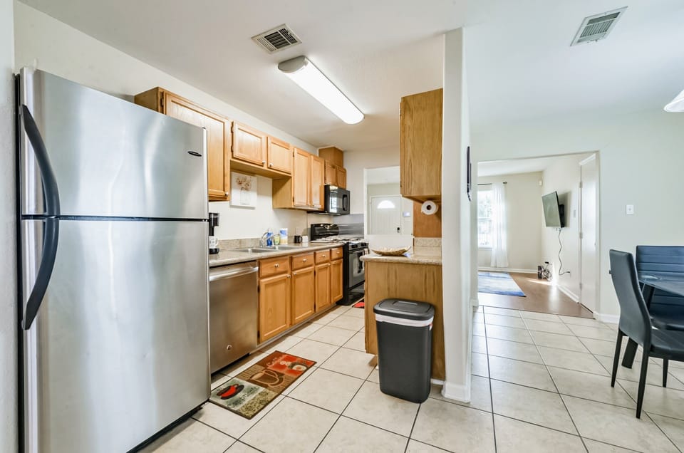 Full kitchen with stove, microwave, dishwasher, and fridge, and coffee maker. 