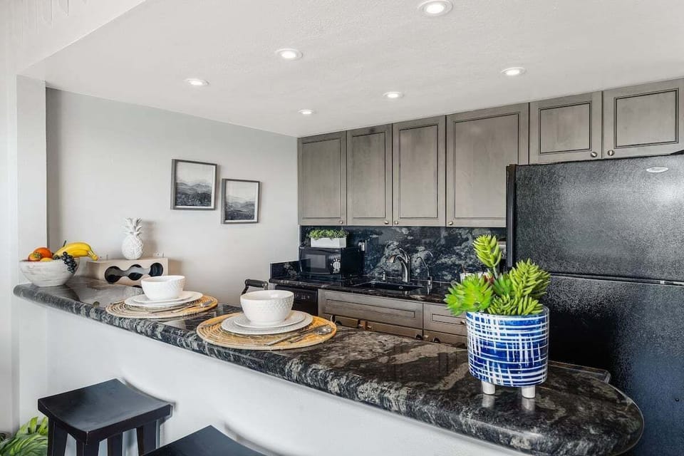 Modern kitchen featuring sleek granite counters and stylish cabinetry