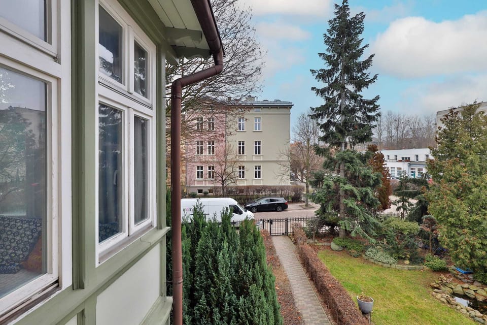A scenic view of the garden and surrounding area from a window.
