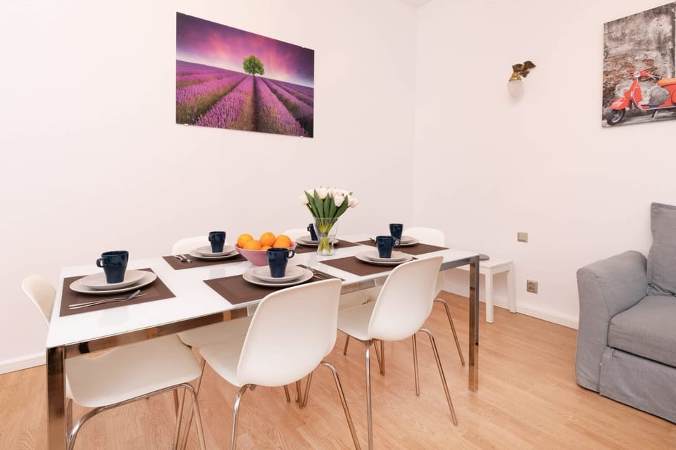 A dining area with a white table and chairs, connected to the living space.
