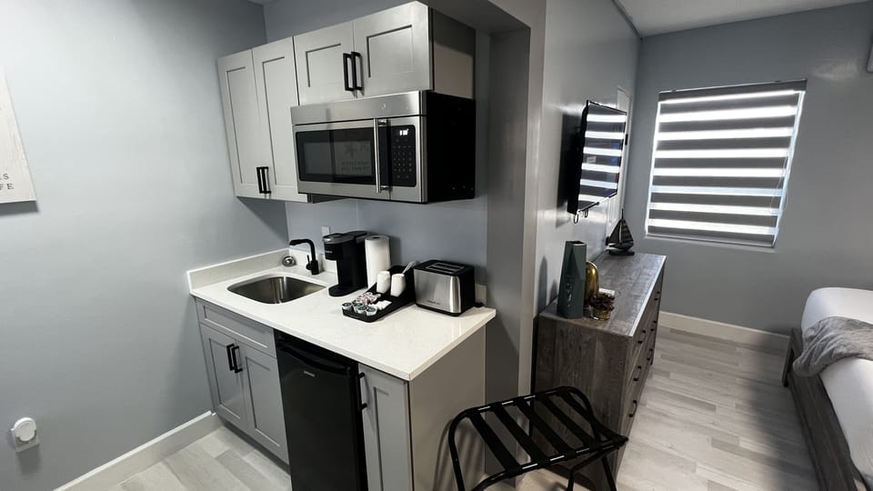 Kitchenette is equipped with mini fridge, microwave, toaster, coffee machine