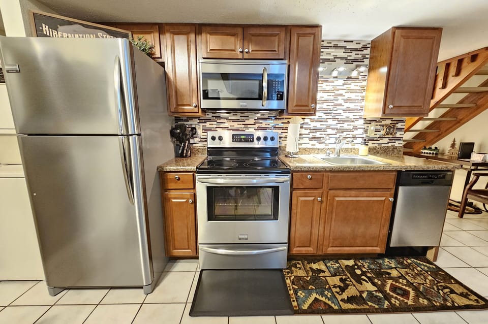 Full-sized stainless-steel appliances, electric cooktop, all dishware included!
