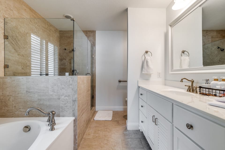 Primary bathroom with soaking tub and essentials.