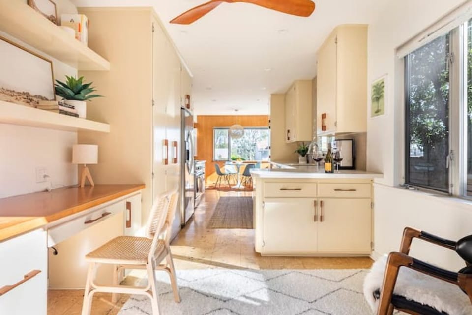 Dedicated work area off of kitchen leads out to patio via French doors. 