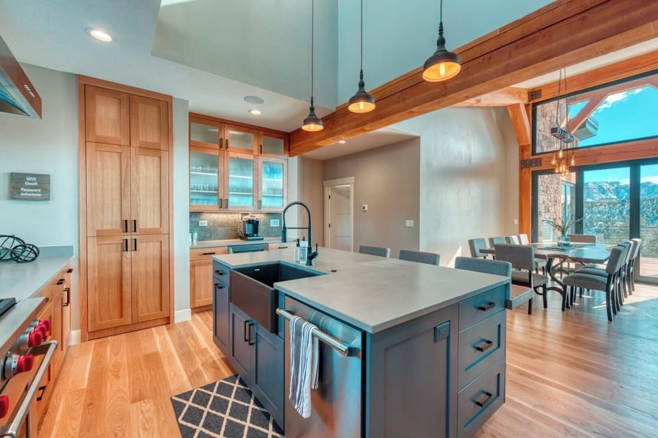 Cook and dine with breathtaking views! This modern kitchen and dining area is perfect for memorable gatherings.