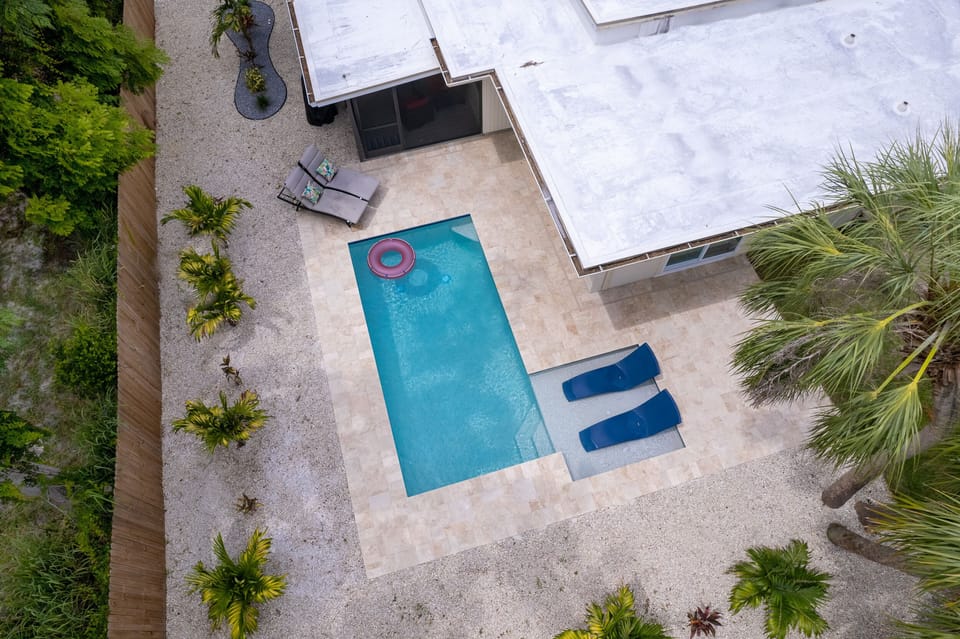 Relax by the new heated pool in the private backyard