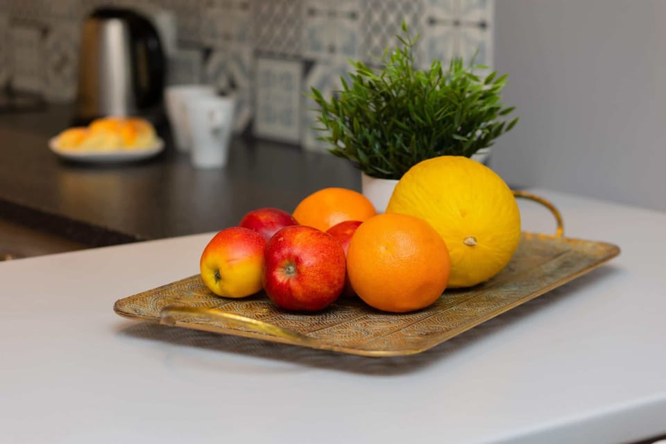 A fresh fruit platter with greenery for a touch of homeliness.
