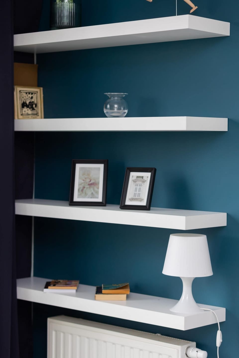 Built-in shelves decorated with minimalistic accessories and books.
