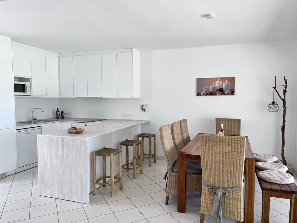 Kitchen with bar and dining table.