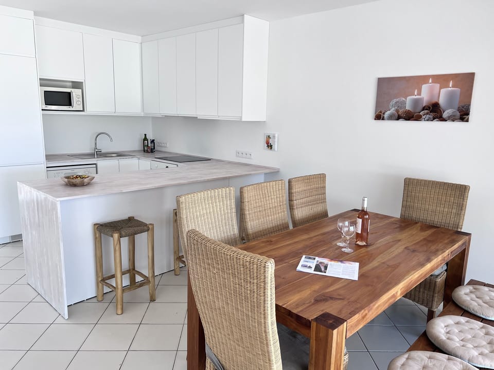 Kitchen with bar and dining table for 8 persons.