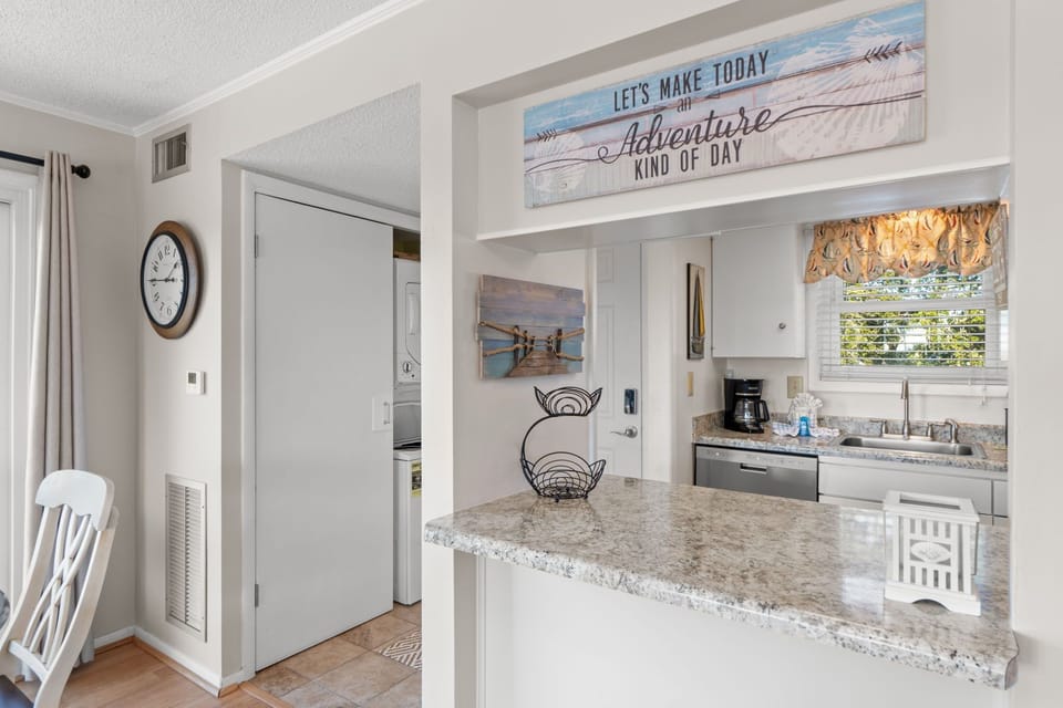 Step into your bright kitchen where adventure-themed artwork sets the mood for memorable vacation meals.