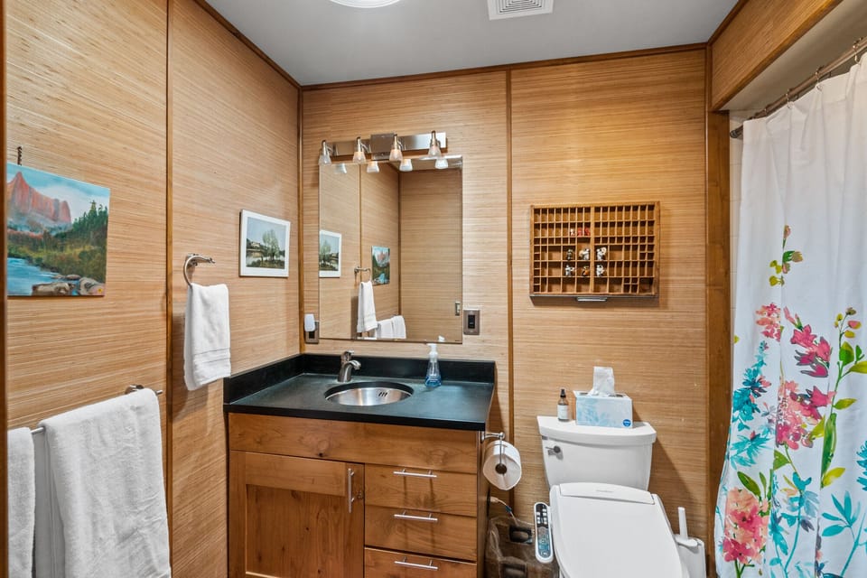 Full bathroom off the kitchen hallway.
