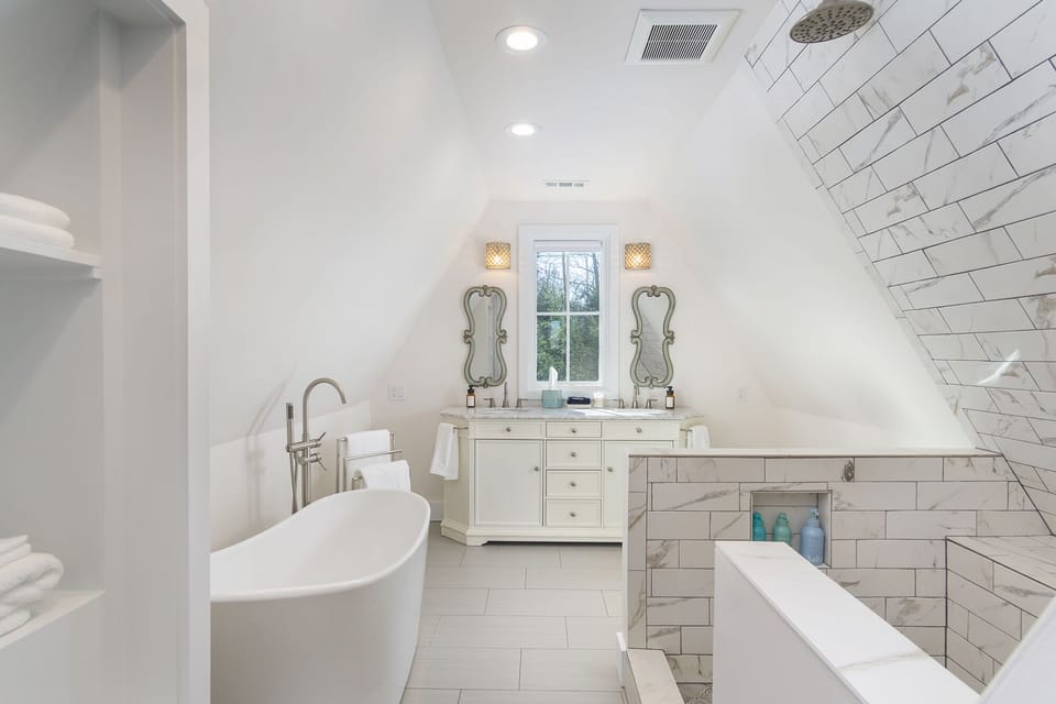 Upstairs full bathroom with unique open shower. Double vanity and bathtub.