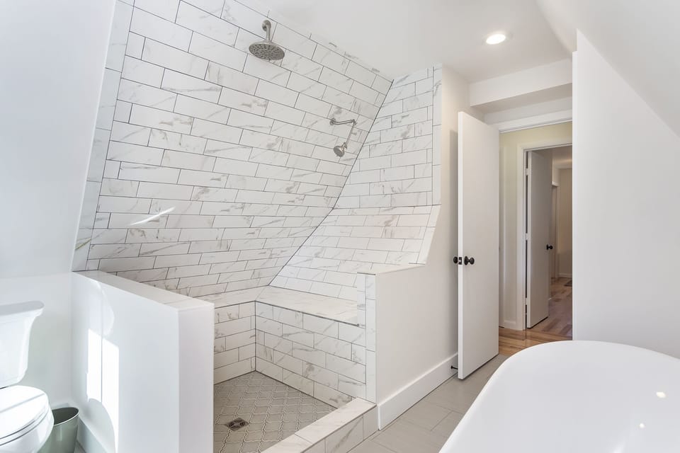 Large, unique open shower with bench.