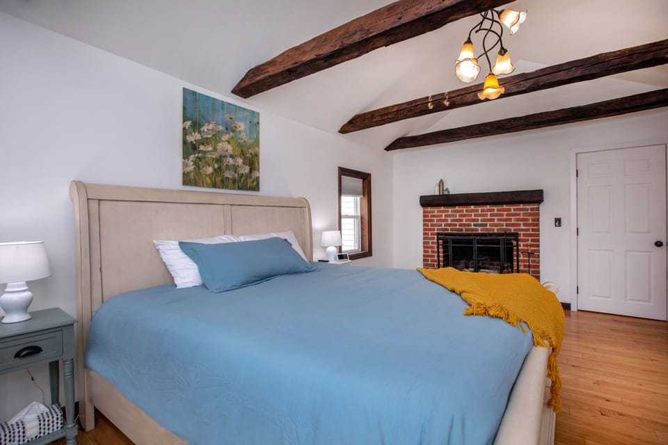 First floor master with comfy king and fireplace.😍