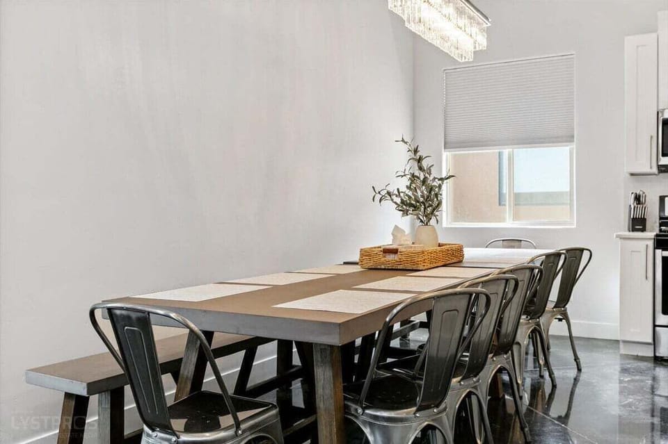 Enjoy meals in this beautiful dining area, highlighted by a large farmhouse table with seating for 12. The combination of natural wood and elegant details sets the stage for lively dinners and special celebrations.