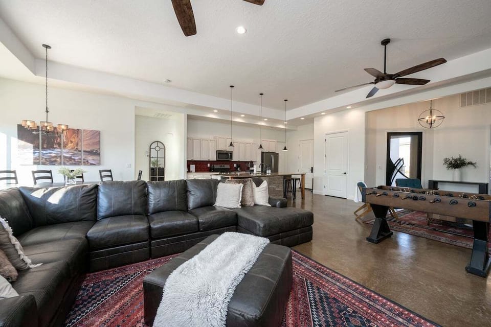 This dynamic living room and dining area is an entertainer's dream. With a stylish sectional for lounging, a foosball table for some friendly competition, it's the perfect blend of dining and play.