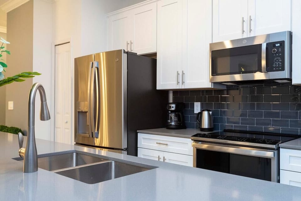 The fully equipped kitchen features modern appliances, sleek cabinetry, and all essential cookware and utensils, making it perfect for preparing meals with ease.