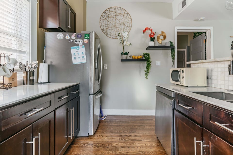 Stainless steel fridge and freezer in full kitchen.