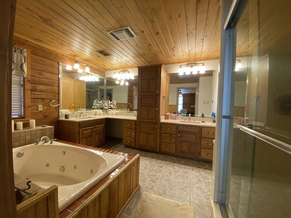 Primary bathroom inside primary bedroom: jet tub, shower, double sinks/vanities