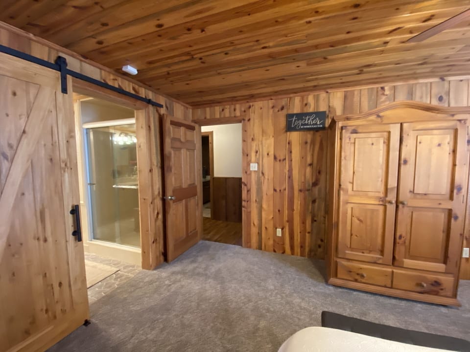 Alternate view of primary king bedroom with sliding barn door to bathroom