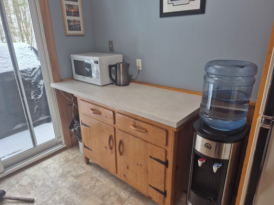 Water cooler with an extra jug of water.  