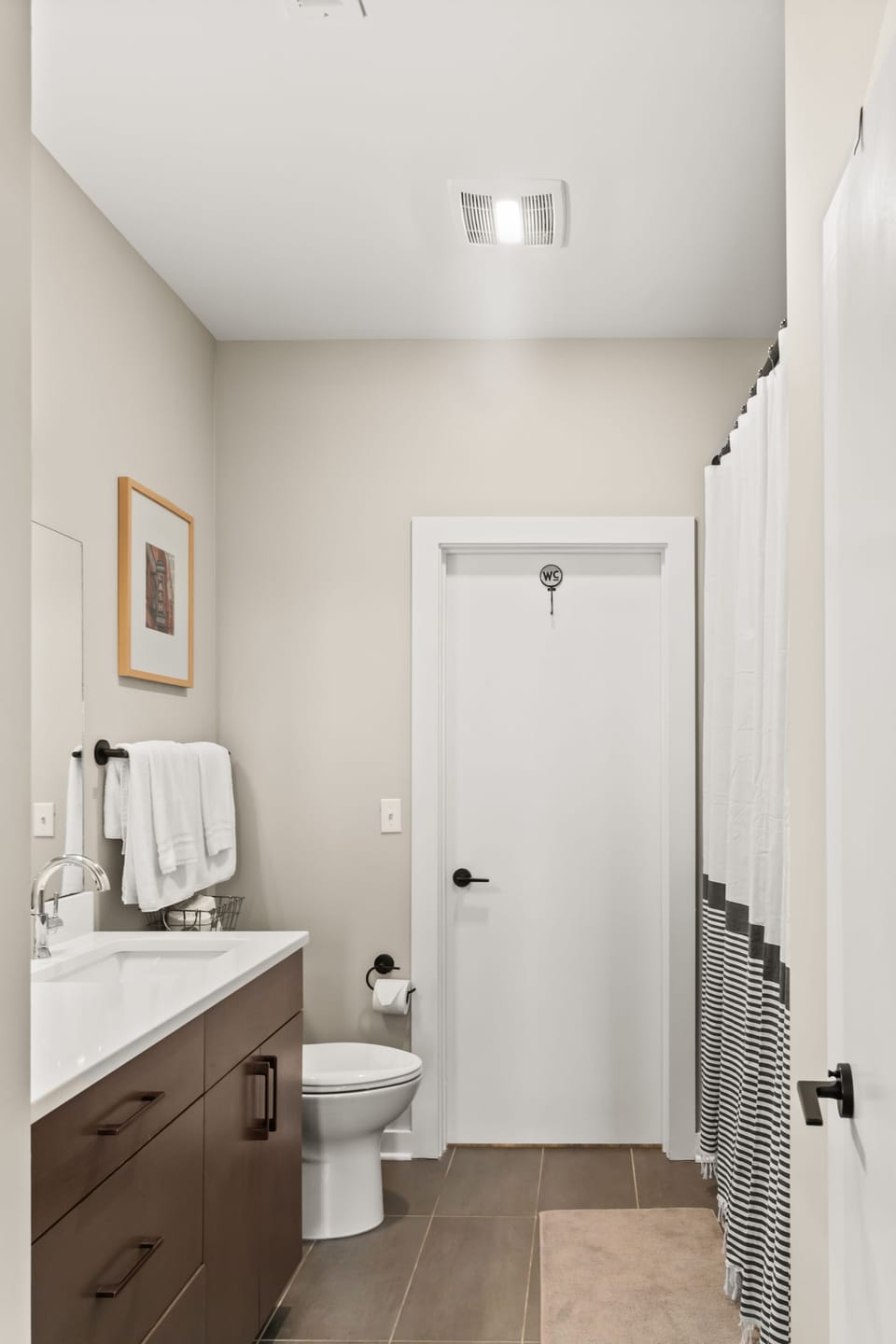 Bathroom is accessible from hallway and master bedroom