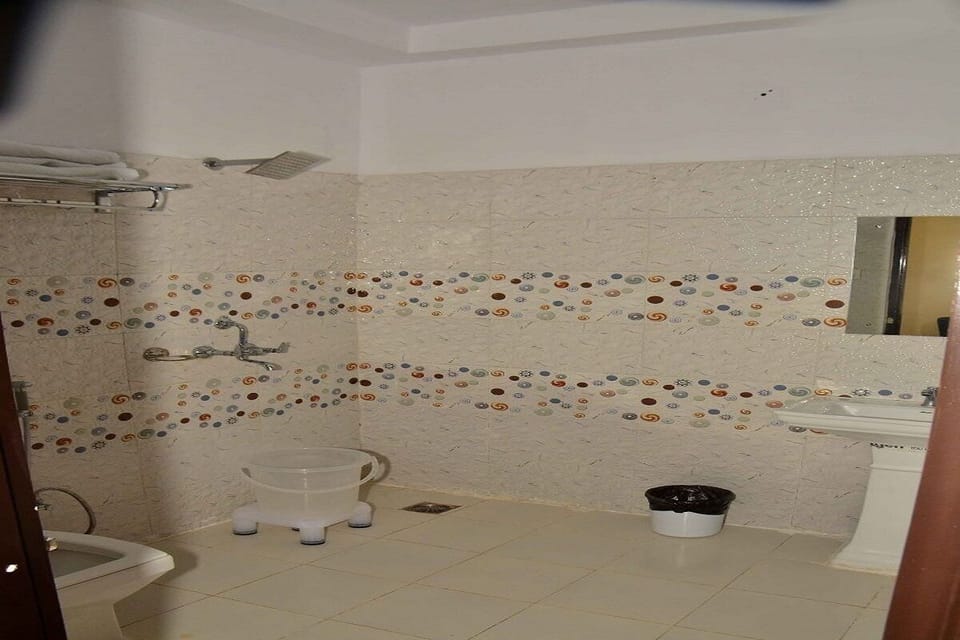 Shower, rainfall showerhead, slippers, towels