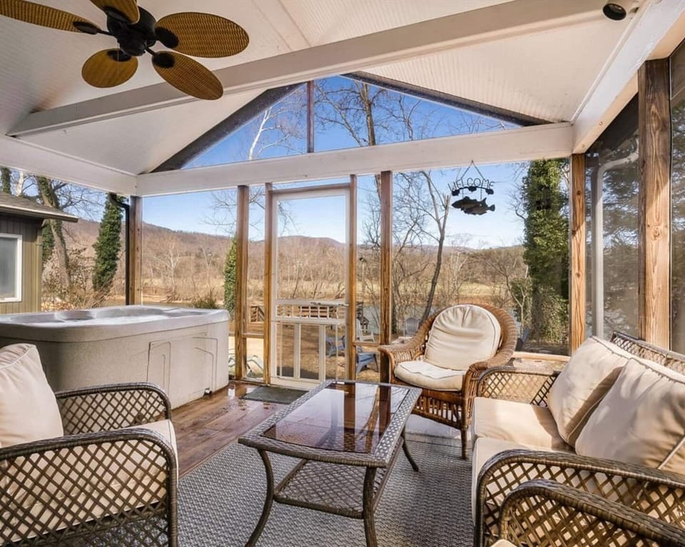 Unwind in the hot tub while taking in the peaceful river views. Enjoy the outdoor patio, complete with comfortable seating, flat-screen TV, and direct access from the primary bedroom.