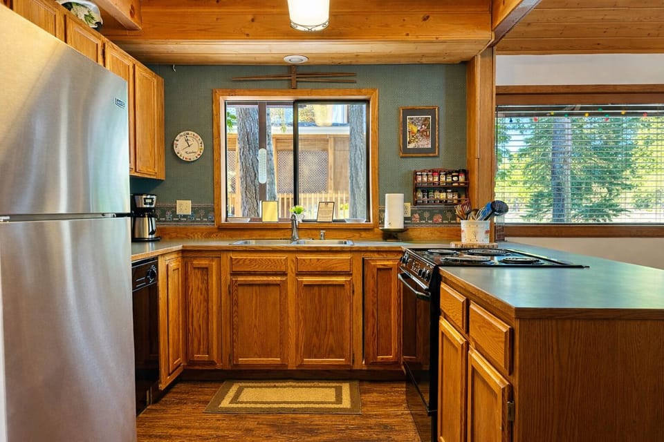 Your fully equipped kitchen features stainless steel appliances, warm wood cabinetry, and everything you need to create memorable meals during your stay.