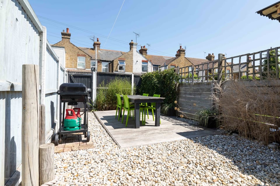 Seaside themed garden with decking and dining table