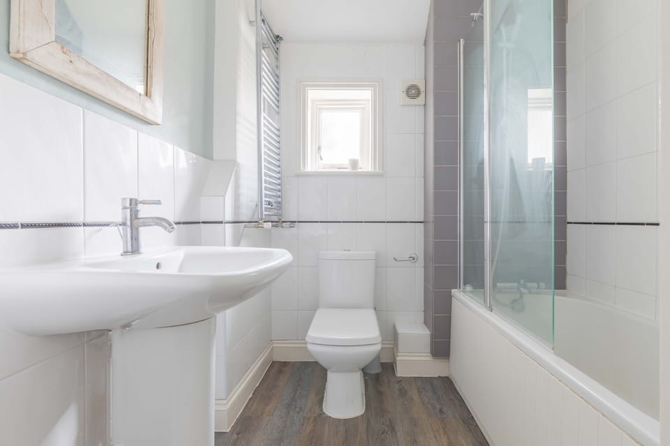 1st floor family bathroom with shower over bath, wc & basin