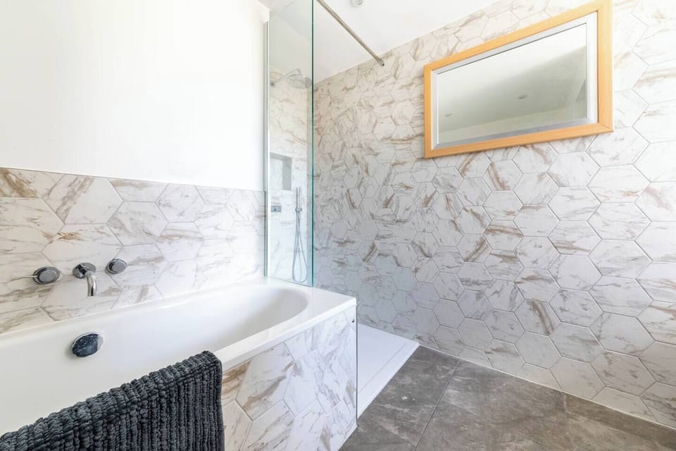 Family bathroom with bath, walk in rain shower, wc & basin