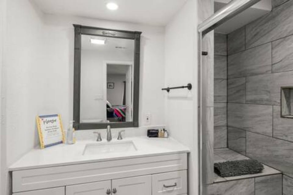 Step into your elegant bathroom featuring a luxurious walk-in shower with beautiful stone-look tiles and modern fixtures for your comfort.