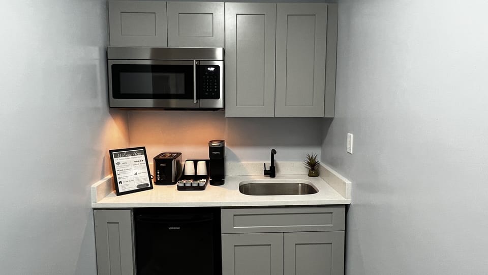Kitchenette is equipped with mini fridge, microwave, toaster, coffee machine