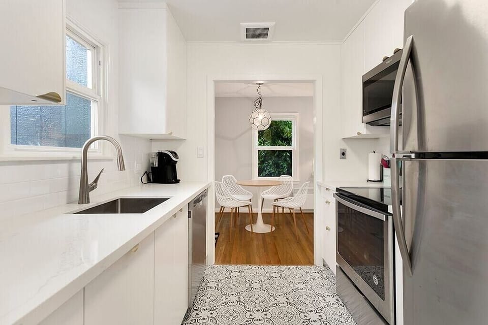 Remodeled kitchen with quartz counters, stainless appliances, and patterned tile — built for real cooking