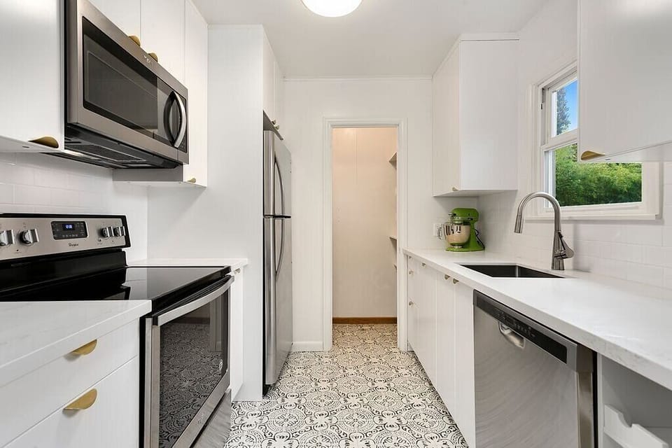 New flat front cabinets, quartz counters, and a fully stocked kitchen ready to use