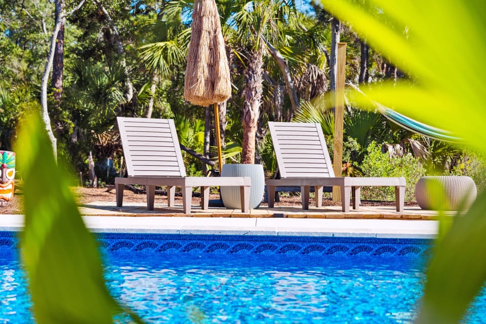Pool side seating in a garden oasis setting