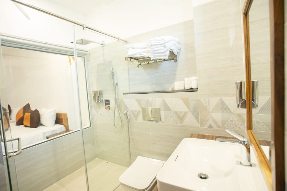 Deluxe Quadruple Room | Bathroom | Shower, designer toiletries, hair dryer, bathrobes