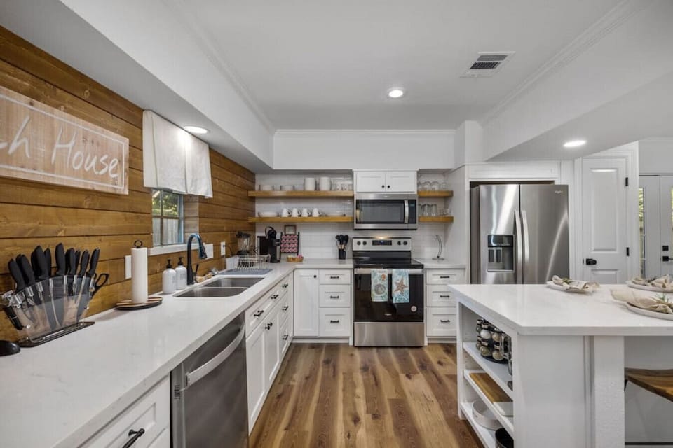 Fully updated kitchen with stainless appliances, quartz countertops, open shelving, and everything you need to cook family meals.