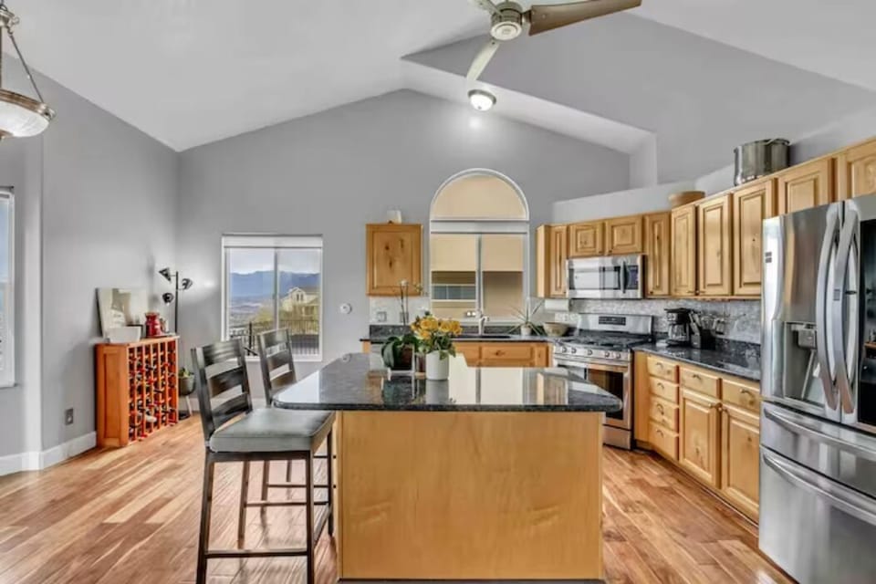 Large open kitchen with granite countertops, new appliances, coffee machine, etc